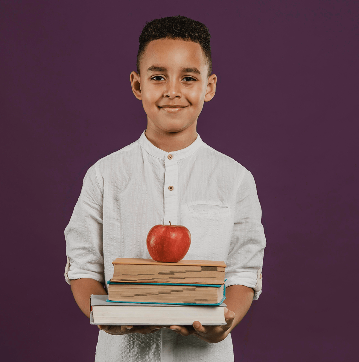 school-boy-holding-books-apple-min